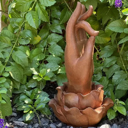 Cast Iron Hand of Buddha Rises from a Lotus Flower