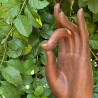 Cast Iron Hand of Buddha Rises from a Lotus Flower